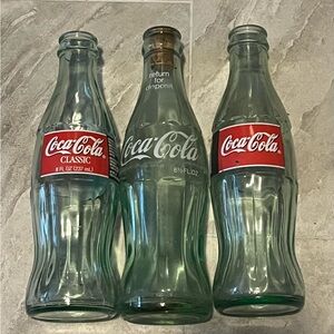 Three vintage Coca-cola bottles